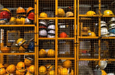 Photo by Pop & Zebra a rack filled with lots of yellow hard hats